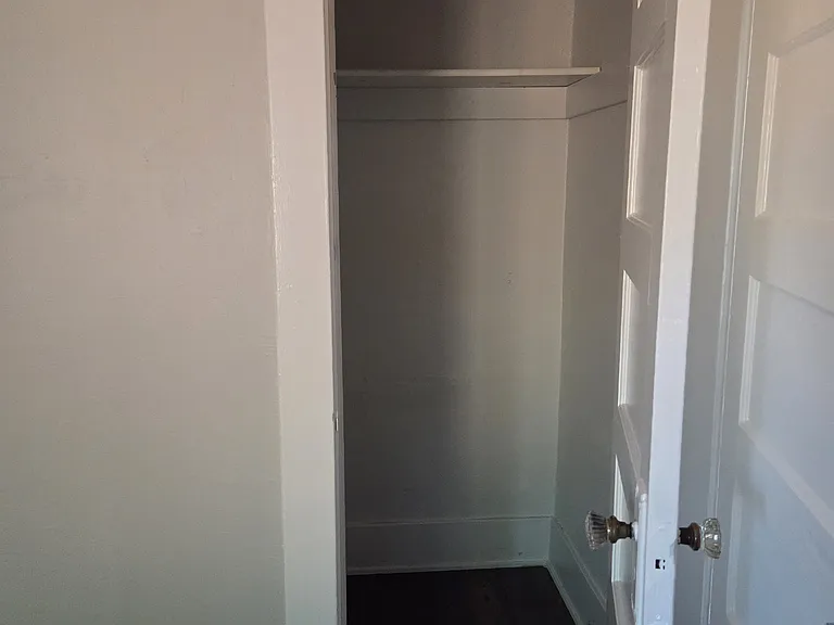 Small, walk in bedroom closet.