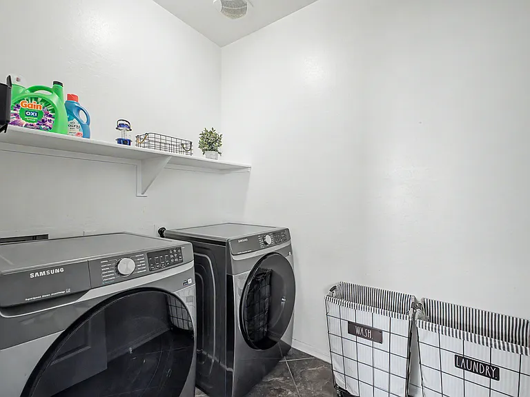 Laundry area with new Samsung washer and dryer.