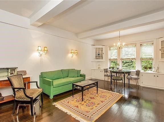Large and bright Living Room elegantly enhanced with built-ins and French doors to kitchen.