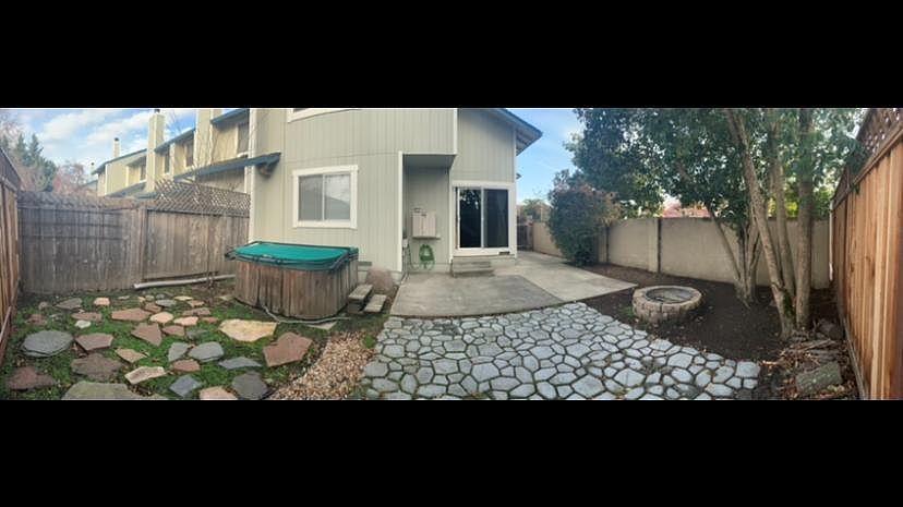 Patio area, firepit, and hot tub
