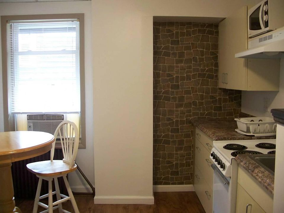 Eat-in kitchen with captain's table and barstools.