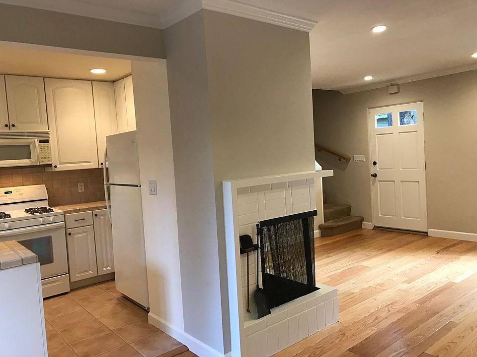 View from standing in the dining area and looking into the kitchen and a portion of the living room.