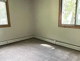 Transform your living space at LS Capital Group with this inviting room, featuring ample natural light and a cozy layout. Imagine your own personal touch in this blank canvas. Schedule a visit today to envision your future home!