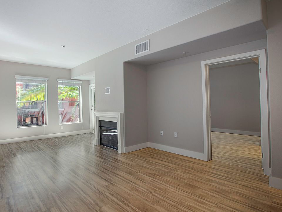 Spacious living room features a fireplace and access to private patio