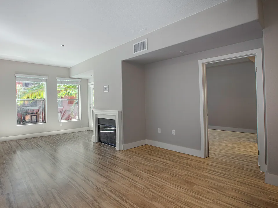 Spacious living room features a fireplace and access to private patio