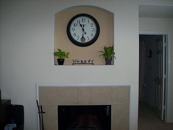 Closer view of fireplace with beautiful art niche.
