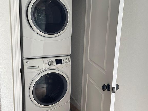 Laundry unit next to kitchen