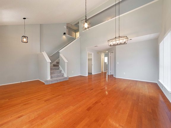 open area with high ceiling - foyer, living, and dining areas
