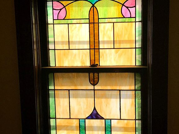 Stained glass window in stairway to apartment