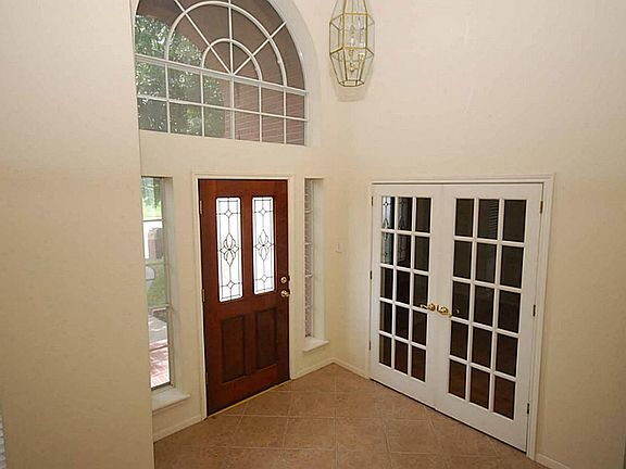 Spacious 2 story foyer with French doors leading to the study.