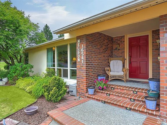 An inviting covered front porch draws you into this home, featuring large, light-filled rooms with picture windows, giant skylights and an open flow for entertaining. 