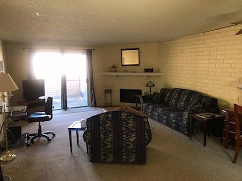 Large Living room, tastefully decorated w wall hanging TV, nice size working desk,