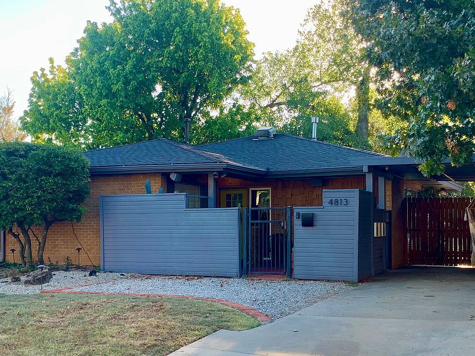 Front of home with enclosed courtyard and portico.