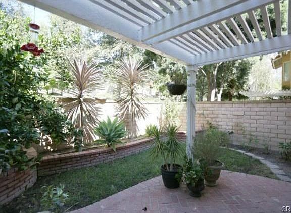Nice backyard with custom landscape, stone fence and patio cover