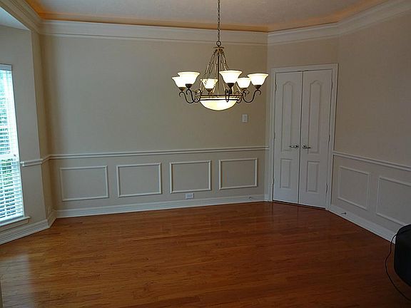 SPACIOUS FORMAL DINING WITH COVE LIGHTING, WOOD FLOORS, A BAY WINDOW, AND BEAUTIFUL CHAIR RAIL MOULDING