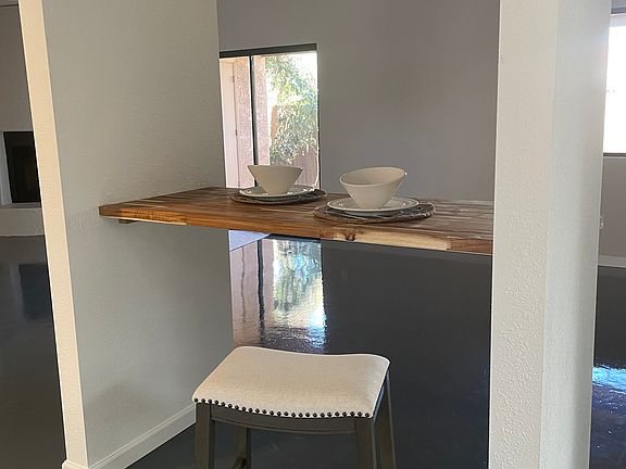 Breakfast bar with two stools and lighting.