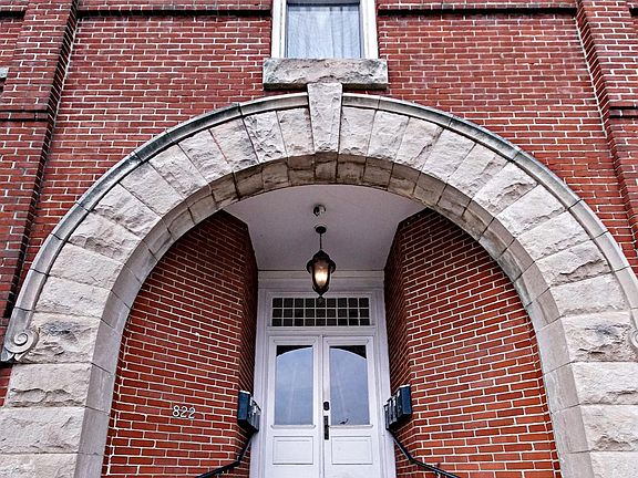 The building entrance is well lit and has an auto-locking smart lock with keypad entry