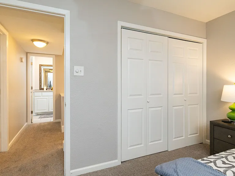 Primary bedroom with king size bed, dresser and fireplace.