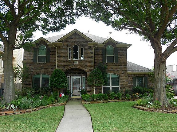 Inviting curb appeal, lush landscaping and mature oak trees.