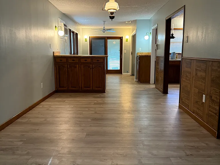 3rd Living room leading to the covered-elevated deck through the sliding glass door. Full size Washer / Dryer closet, inside on the right next to the doors.