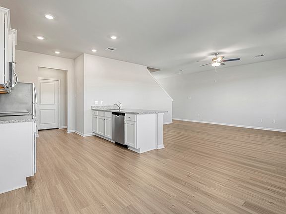 The kitchen overlooks the spacious living area.