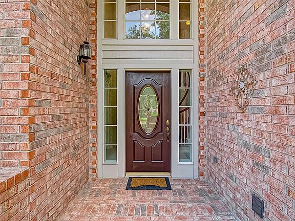 Covered brick front porch (not shown) is a wrought iron privacy gate at front entrance of porch. Sidelight windows and expansive windows above front entry allow natural light to flow through home making it very bright and airy!