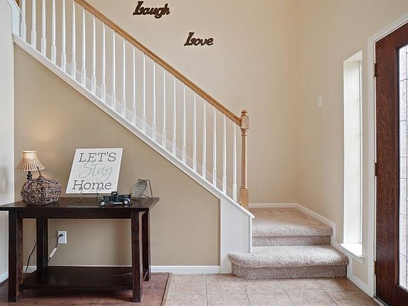 Stairs are located just off the entryway which is accented by a beautiful front door.