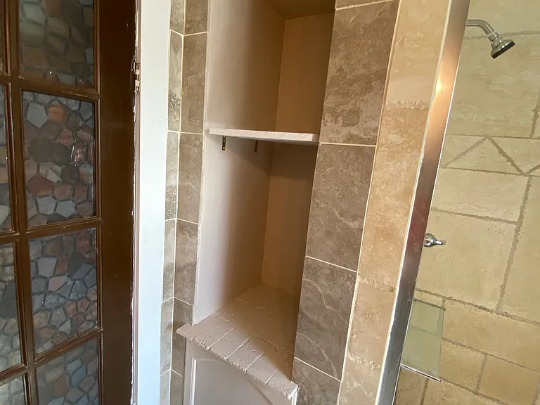 Shelving in bathroom for storage of hygeine products and towels/bath linens.