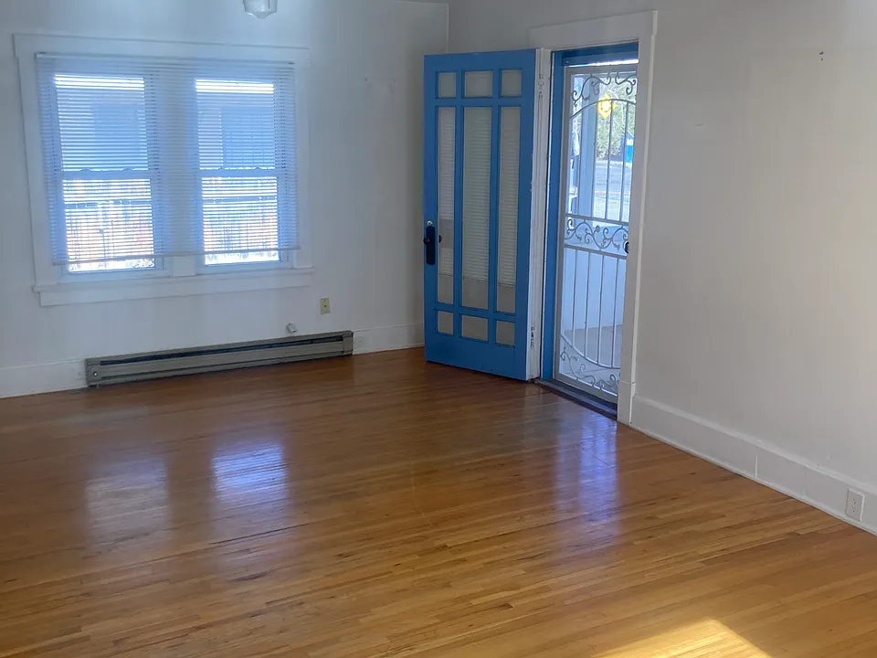 Large 15x30 Living Room with original hardwood floors..