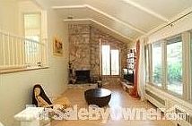 Living room w/ firepl.e + cath. ceilings