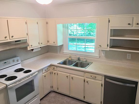 Kitchen, with view of fenced backyard.