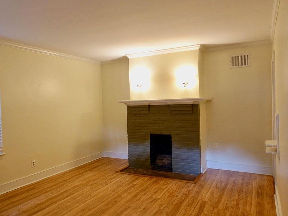 Living room (view from front door) with a decorative firepla