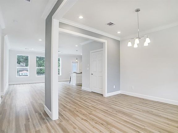 Front door leads to a open concept living area. Dinning area to the right. Living area at the end with plenty of natural light.