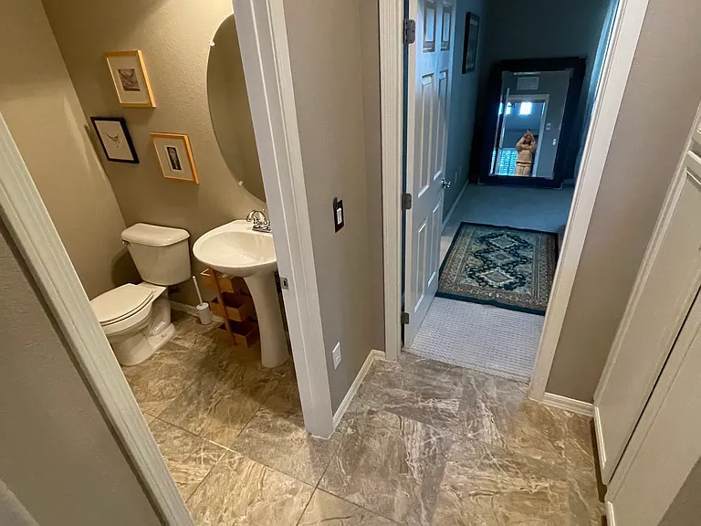 1/2 bath off living area , entry to master bedroom