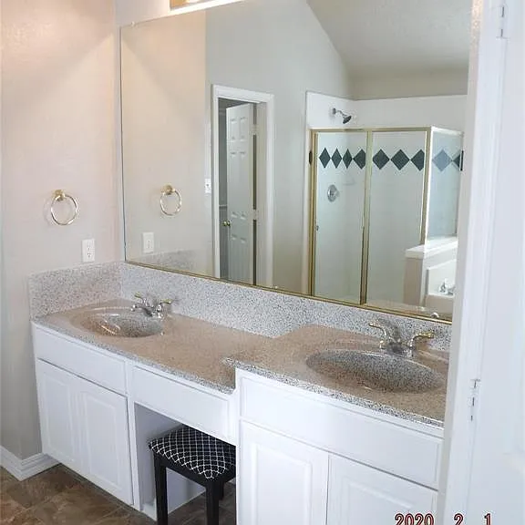 HIS-HER VANITIES, GRANITE, MAKEUP SPACE WITH A CHAIR.