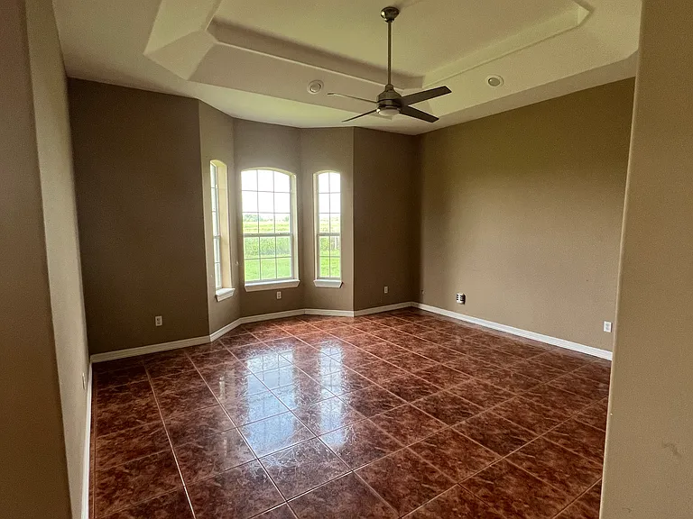 Open and inviting living space featuring large windows and room for a full sectional _ perfect for relaxing, movie nights.