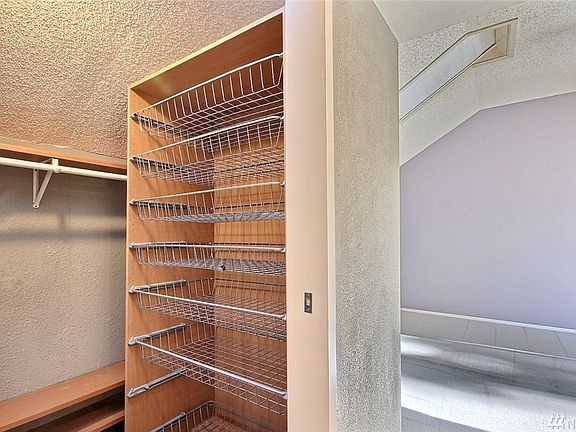 Walk-in closet in master suite with built-in organizers.