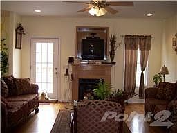 The spacious living room has a TV insert over the gas fireplace.