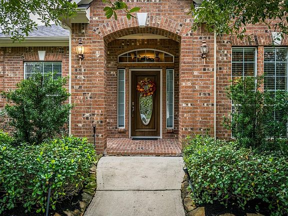 Inviting front porch with lush landscaping.