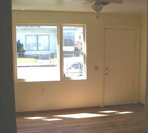 Newly refinished oak floors in sunny living room.