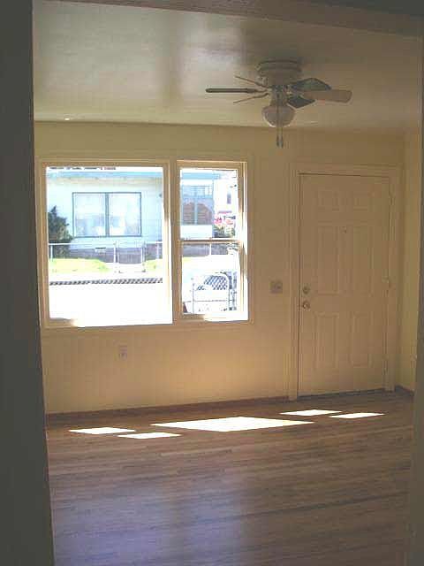 Newly refinished oak floors in sunny living room.