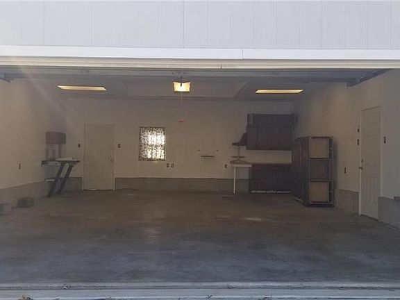 Detached garage has room for 4 cars. Ceiling was raised to make room for a lift. New lighting system.