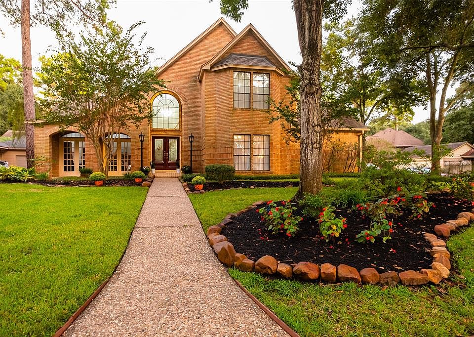 Welcome home! Beautiful corner lot with mature trees and lush landscaping
