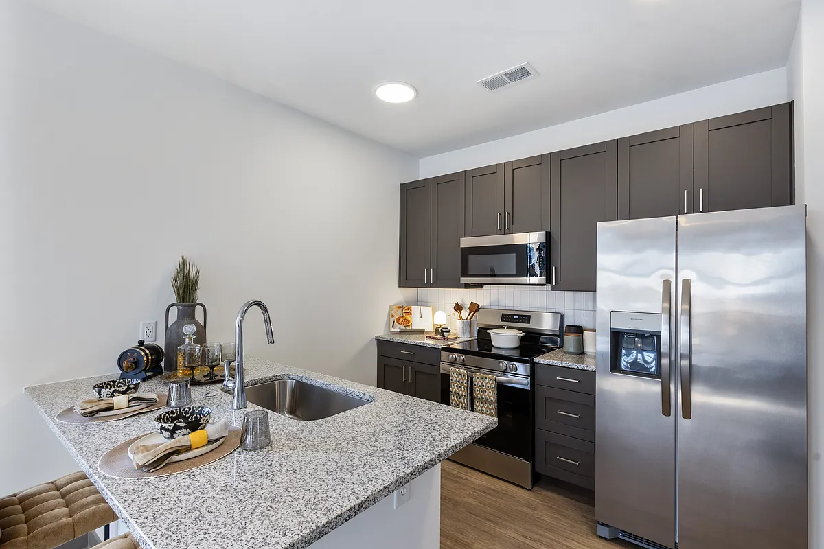 Modern Apartment Kitchen with Granite Island and Stainless Steel Appliances at Montage - Montage West Lafayette