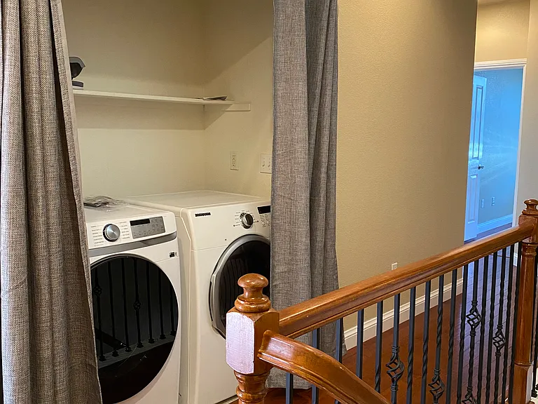 Laundry area between master bedroom and secondary bedrooms