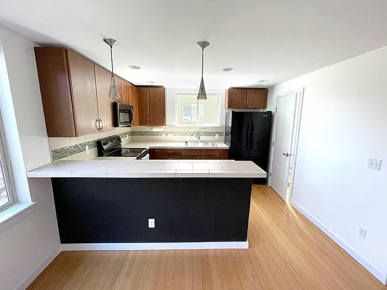 Looking back at kitchen from living room, breakfast bar