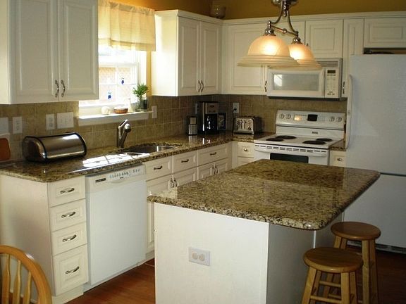 Granite and tile Kitchen with hardwood floors
