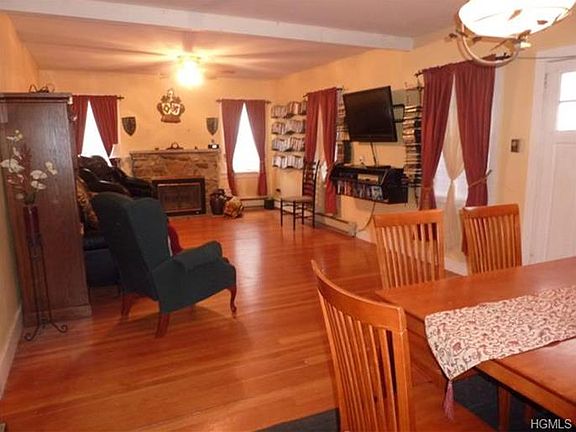 Living room, dining room combination with gleaming hardwood floors.