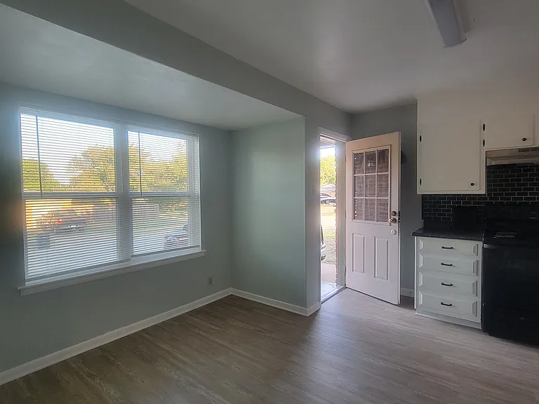 Front of kitchen with eating area in front of windows.