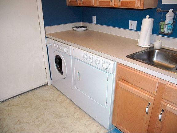 Kitchen with under the counter washer and dryer